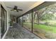 Expansive screened porch showcasing backyard with mature trees and scenic lake view at 2504 Tanglewood Dr, Sarasota, FL 34239