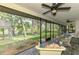Inviting screened porch with views of landscaped backyard and lake at 2504 Tanglewood Dr, Sarasota, FL 34239