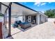 Covered patio with comfortable seating and a brick-paved patio offers a perfect outdoor entertaining area at 12829 Kings Lake Dr, Gibsonton, FL 33534