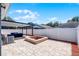 Spacious backyard with a fire pit, covered patio, and privacy fence is ideal for outdoor gatherings at 12829 Kings Lake Dr, Gibsonton, FL 33534