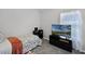 Comfortable bedroom features a cozy bed, a desk, and a TV for relaxing evenings at 12829 Kings Lake Dr, Gibsonton, FL 33534