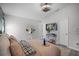 Bright bedroom features a modern ceiling fan and wall-mounted television for comfortable viewing at 12829 Kings Lake Dr, Gibsonton, FL 33534
