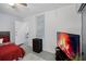 Bedroom with window, TV, and dresser creates a welcoming and functional space at 12829 Kings Lake Dr, Gibsonton, FL 33534