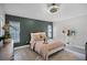 Well-lit bedroom with modern ceiling fan, stylish decor, and neutral-toned walls and wood-style flooring at 12829 Kings Lake Dr, Gibsonton, FL 33534