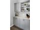 Kitchen featuring modern cabinets, countertops, updated appliances, and decorative shelving at 12829 Kings Lake Dr, Gibsonton, FL 33534