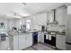 Updated kitchen with granite countertops, stainless steel appliances, and an open layout design at 12829 Kings Lake Dr, Gibsonton, FL 33534