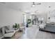 Inviting living room featuring hardwood flooring, an open concept layout, and abundant natural light at 12829 Kings Lake Dr, Gibsonton, FL 33534