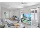 Comfortable living room with hardwood floors, a large television, and a cozy seating area at 12829 Kings Lake Dr, Gibsonton, FL 33534