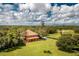 Expansive aerial view of estate surrounded by lush greenery and a scenic landscape at 37511 Washington Loop Road, Punta Gorda, FL 33982