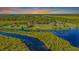 Aerial view of estate homes situated on a riverine landscape at 37511 Washington Loop Road, Punta Gorda, FL 33982