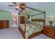 Bedroom with four-poster bed, ceiling fan, and tropical decor at 37511 Washington Loop Road, Punta Gorda, FL 33982
