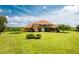 Sprawling estate boasts a terracotta roof, lush landscaping, and expansive green lawn at 37511 Washington Loop Road, Punta Gorda, FL 33982