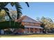 Charming two-story home with brown tile roof and beautiful landscaping at 37511 Washington Loop Road, Punta Gorda, FL 33982