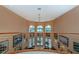 Foyer featuring a vaulted ceiling, iron railing, and arched windows with water views at 37511 Washington Loop Road, Punta Gorda, FL 33982