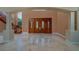 Welcoming foyer showcasing wooden doors and elegant staircase at 37511 Washington Loop Road, Punta Gorda, FL 33982