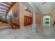 Grand foyer featuring a curved wood staircase and a light color scheme at 37511 Washington Loop Road, Punta Gorda, FL 33982