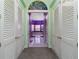 Hallway leading to bathroom with double doors and a decorative transom window at 37511 Washington Loop Road, Punta Gorda, FL 33982