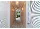 Bright hallway featuring marble floors and decorative lighting fixtures leading to the main bedroom at 37511 Washington Loop Road, Punta Gorda, FL 33982