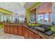 Kitchen featuring stone countertops, wood cabinetry, and a scenic backyard view at 37511 Washington Loop Road, Punta Gorda, FL 33982
