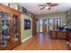 Home office with hardwood floors, built-in shelving, and glass doors overlooking the water at 37511 Washington Loop Road, Punta Gorda, FL 33982