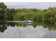 Beautiful view of a couple enjoying a relaxing time on the lake in a white pedal boat at 37511 Washington Loop Road, Punta Gorda, FL 33982