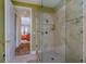 Walk-in tiled shower with glass door, showcasing modern design elements at 37511 Washington Loop Road, Punta Gorda, FL 33982