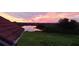Scenic view of the sunset reflecting over the lake and sky as viewed from the property at 37511 Washington Loop Road, Punta Gorda, FL 33982