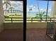 Balcony view featuring the ocean, bridge, and palm trees at 115 1St E St # 103, Tierra Verde, FL 33715