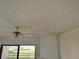 Ceiling with water stains, fan, and the sliding glass door to the balcony at 115 1St E St # 103, Tierra Verde, FL 33715