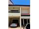 Condo exterior showcasing carports, unit entries, and a warm, neutral color palette at 115 1St E St # 103, Tierra Verde, FL 33715