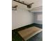 Unfinished garage with garage door opener and partial flooring at 115 1St E St # 103, Tierra Verde, FL 33715