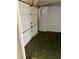 View of the garage with an open door and artificial turf flooring, providing a unique and functional space at 115 1St E St # 103, Tierra Verde, FL 33715