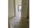 Hallway with walls leading to a room with a sliding glass door at 115 1St E St # 103, Tierra Verde, FL 33715