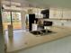 Features a kitchen with white cabinets, black appliances and a breakfast bar area at 115 1St E St # 103, Tierra Verde, FL 33715