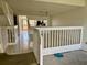 Open-concept living room features tile flooring and staircase leading to the upper level at 115 1St E St # 103, Tierra Verde, FL 33715