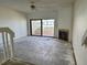 Spacious living room with a fireplace and a sliding glass door to a balcony at 115 1St E St # 103, Tierra Verde, FL 33715