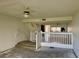 View of the living room with stairs and a ceiling fan at 115 1St E St # 103, Tierra Verde, FL 33715