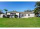A well-maintained backyard with a lush green lawn and a view of the home's rear exterior at 11212 3Rd E Ave, Bradenton, FL 34212