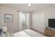 Comfortable bedroom with a window, closet, and adjacent TV, perfect for relaxing at 11212 3Rd E Ave, Bradenton, FL 34212