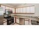 Modern kitchen featuring stainless steel appliances, granite countertops, and white cabinetry at 11212 3Rd E Ave, Bradenton, FL 34212