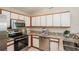 Modern kitchen with stainless steel appliances and granite countertops offers style and function at 11212 3Rd E Ave, Bradenton, FL 34212