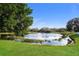 A beautiful scenic view of a peaceful pond surrounded by lush greenery and trees at 11212 3Rd E Ave, Bradenton, FL 34212
