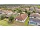 Overhead view showcasing the home's backyard patio, pool, and well-kept lawn in a suburban setting at 12784 Burns Dr, Odessa, FL 33556