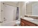 Bathroom featuring tub with shower, granite vanity, and neutral walls at 12784 Burns Dr, Odessa, FL 33556