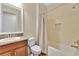 Neutral bathroom featuring tub with shower, light walls, and granite vanity at 12784 Burns Dr, Odessa, FL 33556
