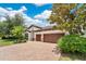 Beautiful home featuring a brick paver driveway, lush landscaping, and a tile roof, creating an inviting and picturesque curb appeal at 12784 Burns Dr, Odessa, FL 33556