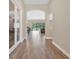 Inviting hallway featuring neutral walls, stylish wood-look tile flooring, and archways, leading to the various living spaces at 12784 Burns Dr, Odessa, FL 33556