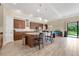 Modern kitchen boasting stainless steel appliances, a spacious island with seating, and access to the outdoor patio at 12784 Burns Dr, Odessa, FL 33556