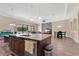 Open-concept kitchen with granite counters, stainless appliances, and view of the living area and outdoor space at 12784 Burns Dr, Odessa, FL 33556