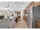 Spacious kitchen with a large island, granite countertops, stainless appliances, and wood-look tile flooring at 12784 Burns Dr, Odessa, FL 33556